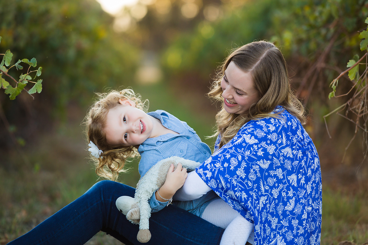 Mum and daughter sitting on a rug in the vineyards family photography