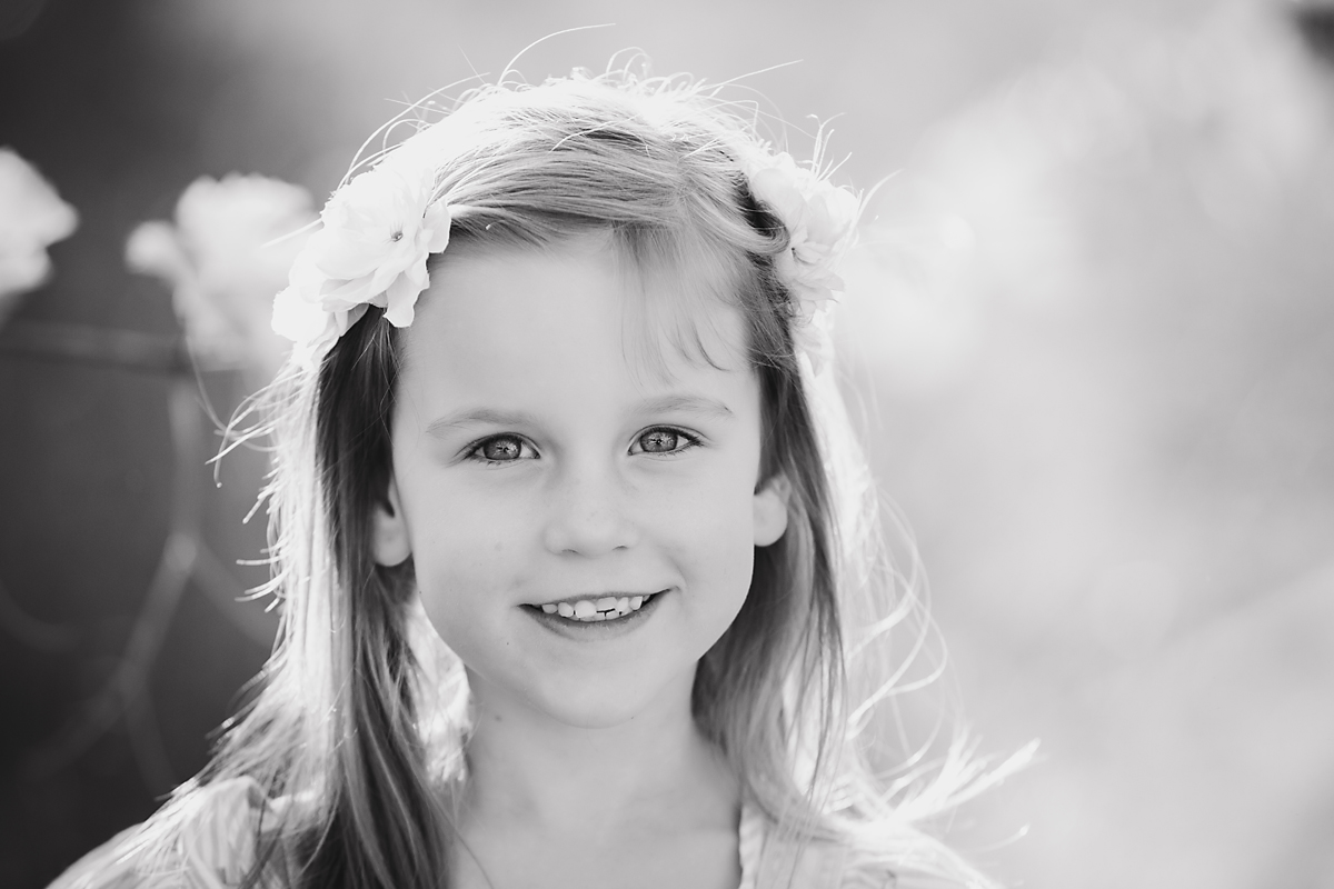 girl smiling and posing for family photos by deb elton photography